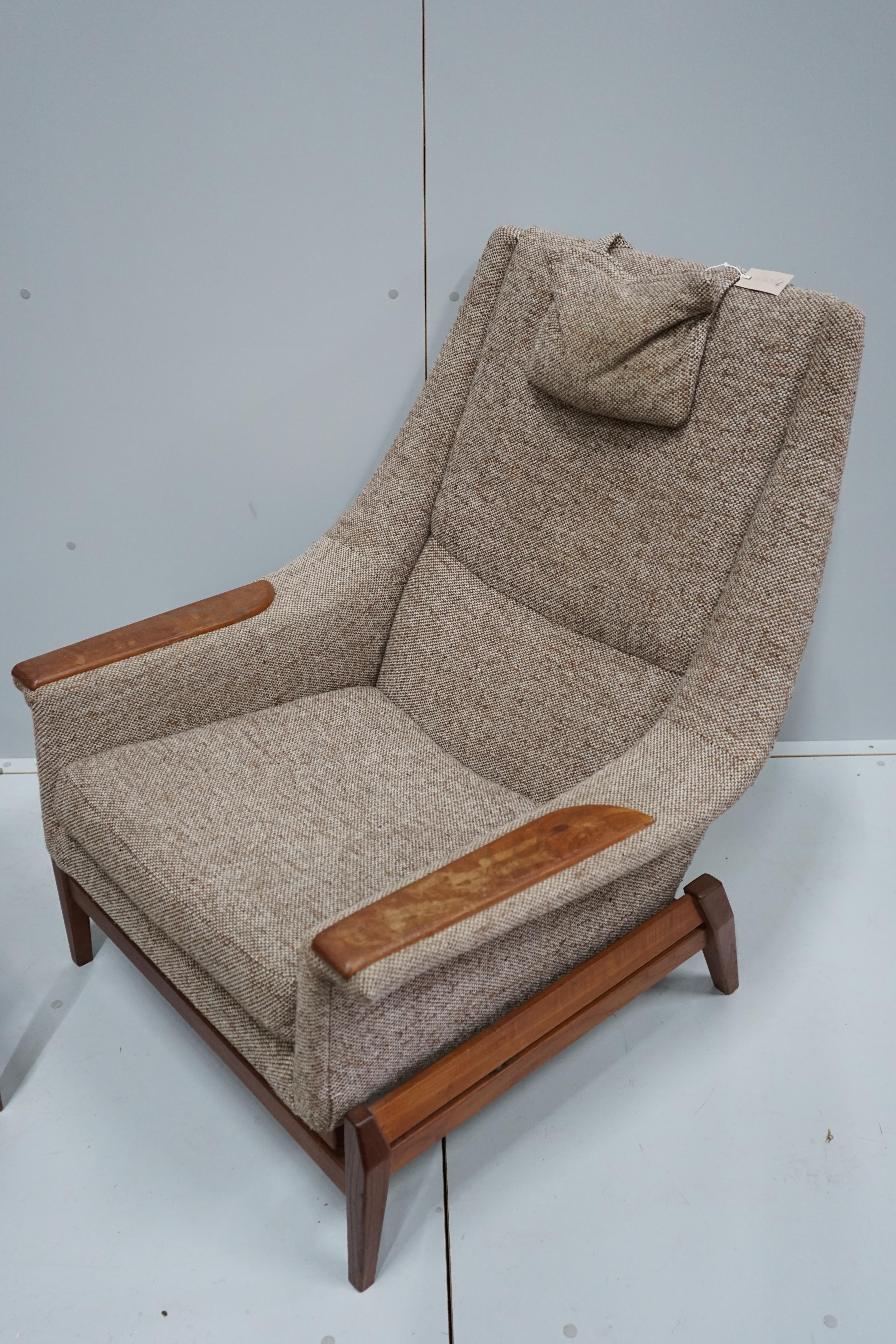 In the manner of Kofod Larsen, a mid century upholstered teak reclining armchair and adjustable foot stool, chair width 87cm, depth 86cm, height 102cm.